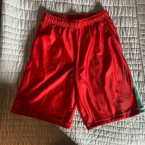 Boys red and light blue Nike basketball shorts